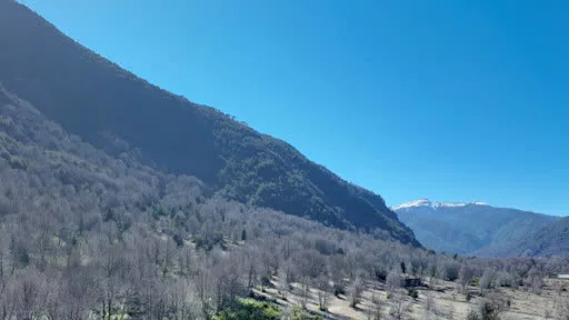 Tour virtual 360° de Casa AvA, refugio de montaña con vista aérea al valle y cumbres nevadas